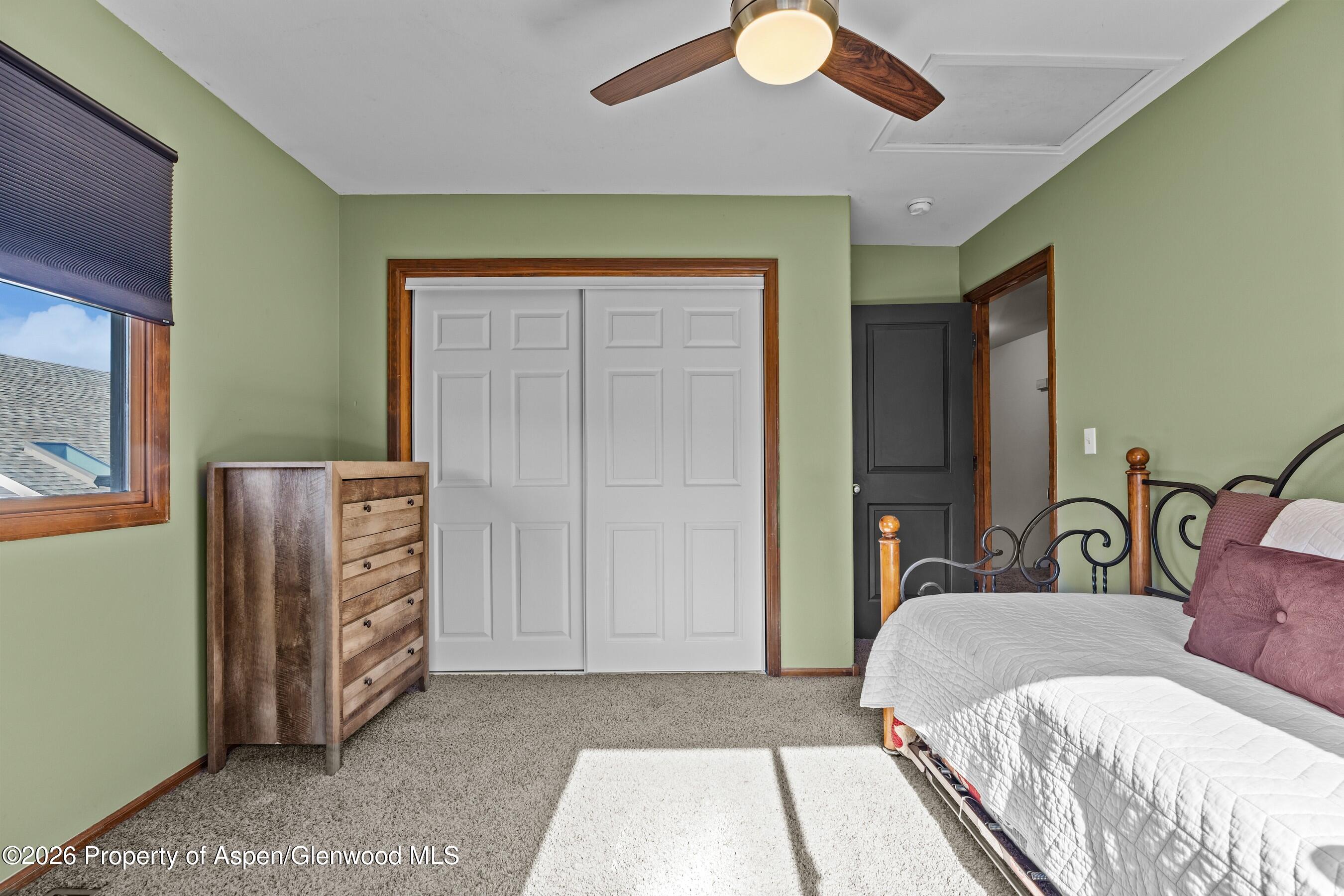 212 Safflower Court New Castle, CO 81647 - Photo 16 of 27 a bedroom with a bed and a dresser