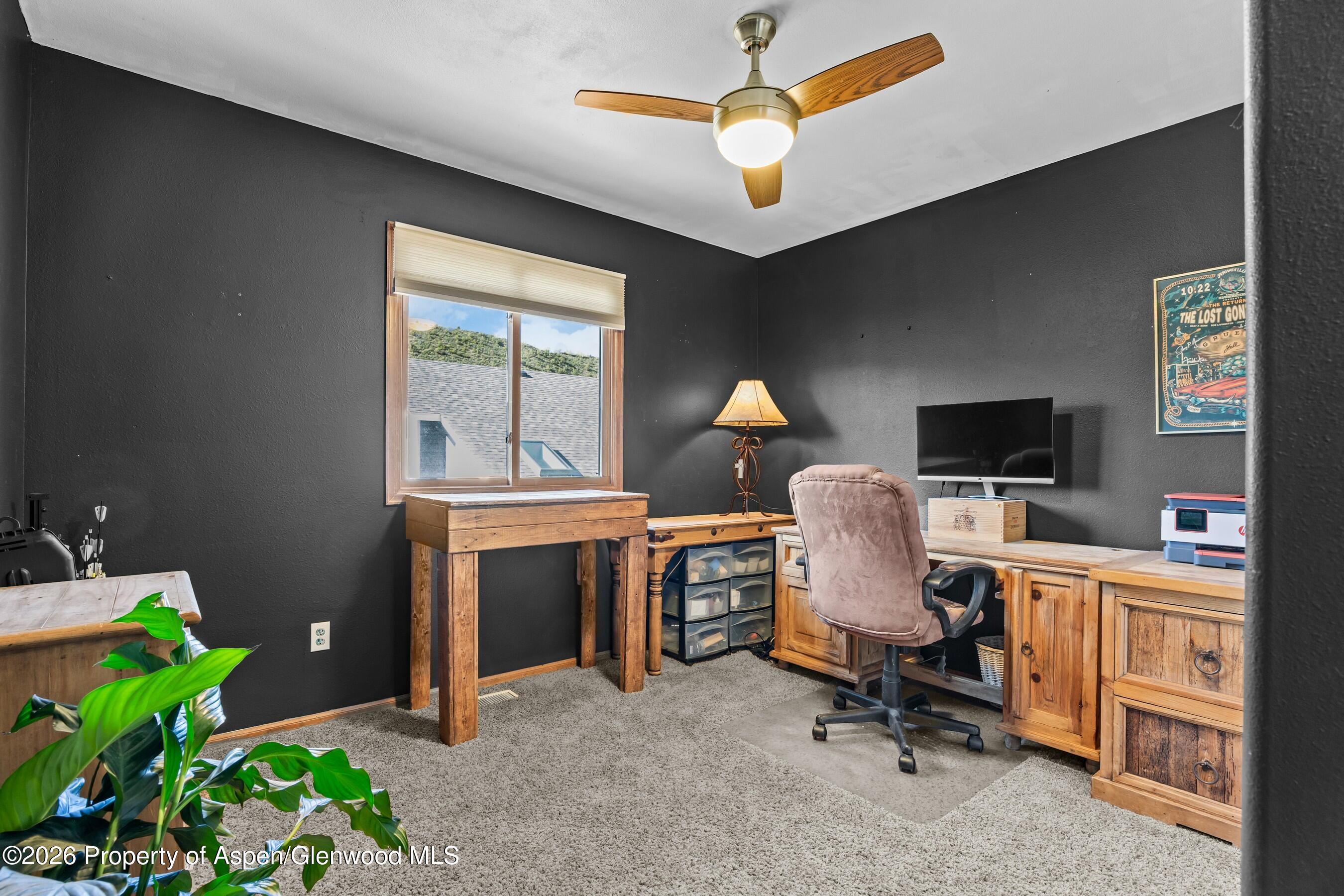 212 Safflower Court New Castle, CO 81647 - Photo 17 of 27 a view of a workspace with furniture and a window