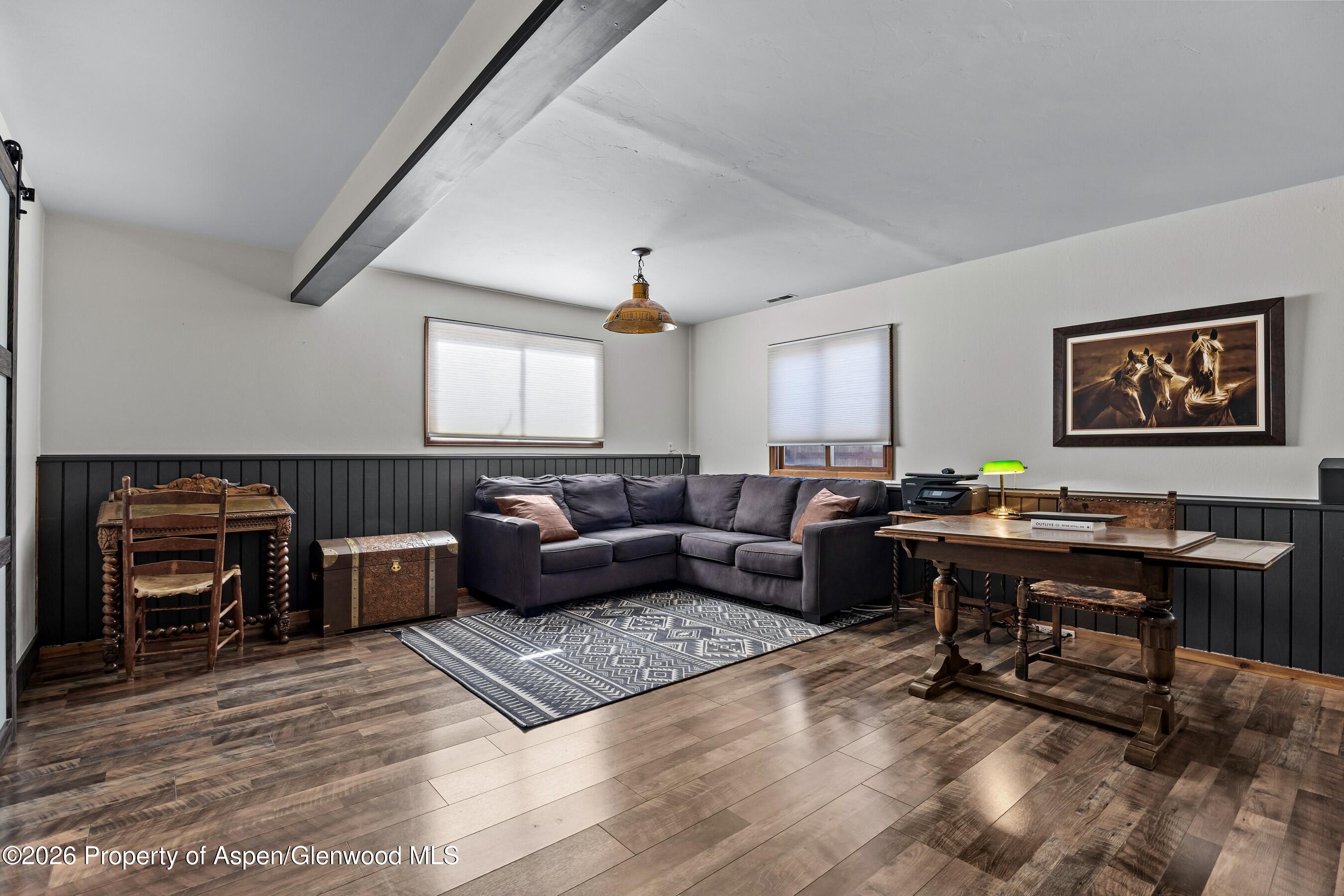 212 Safflower Court New Castle, CO 81647 - Photo 19 of 27 a living room with furniture a piano and a flat screen tv