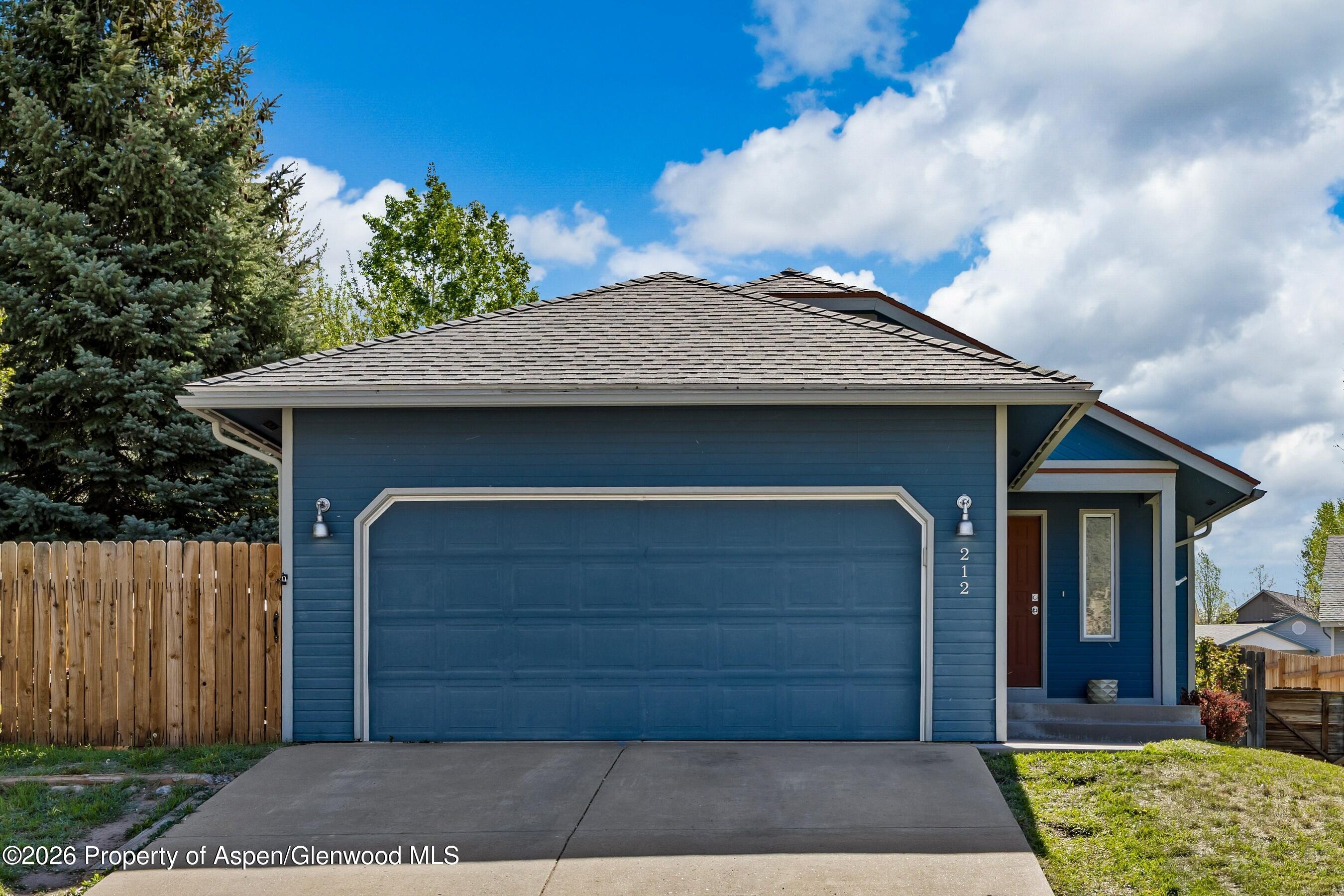 212 Safflower Court New Castle, CO 81647 - Photo 2 of 27 a front view of a house with a garden