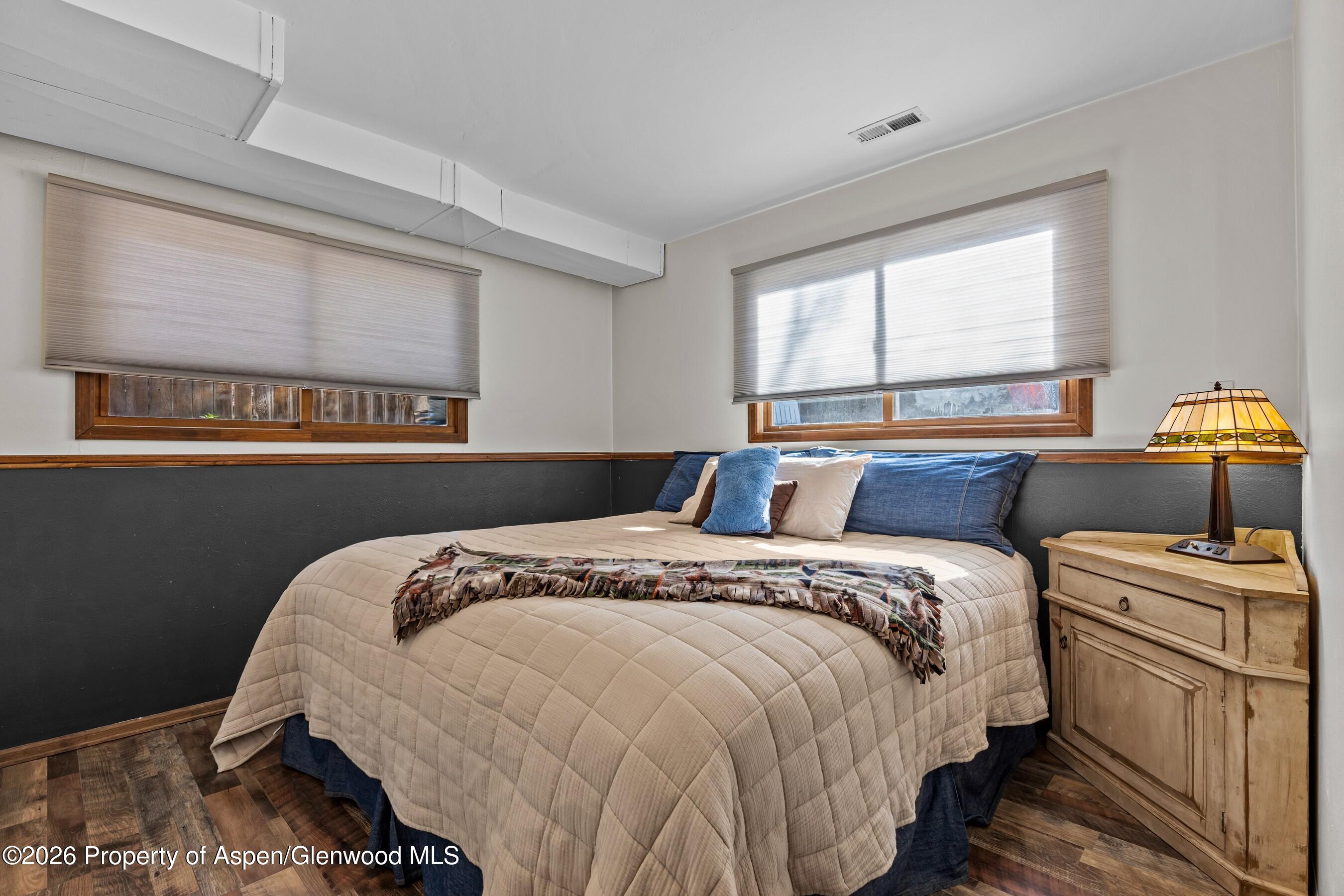 212 Safflower Court New Castle, CO 81647 - Photo 21 of 27 a bed sitting in a bedroom next to a window