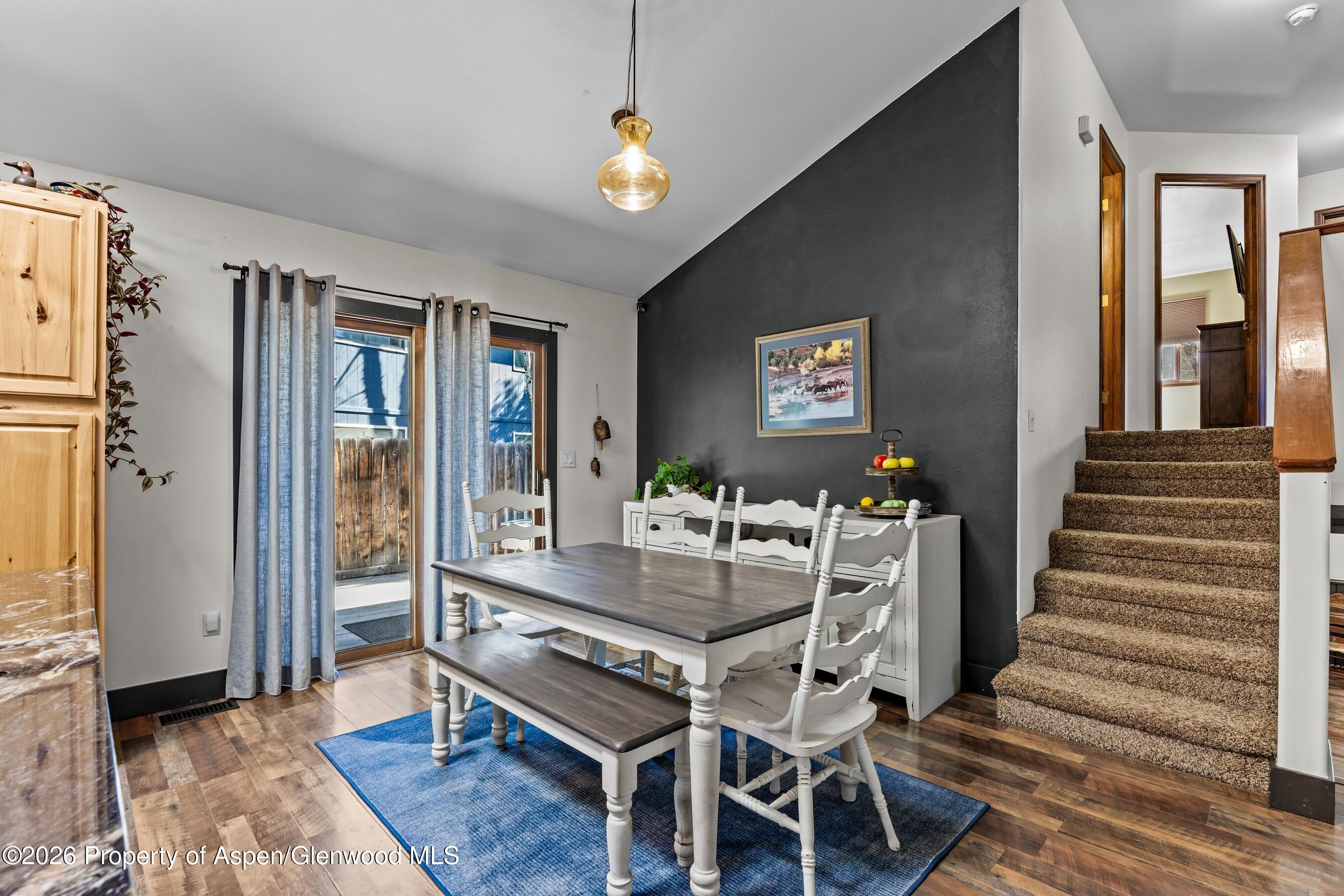 212 Safflower Court New Castle, CO 81647 - Photo 6 of 27 a dining room with wooden floor and a chandelier