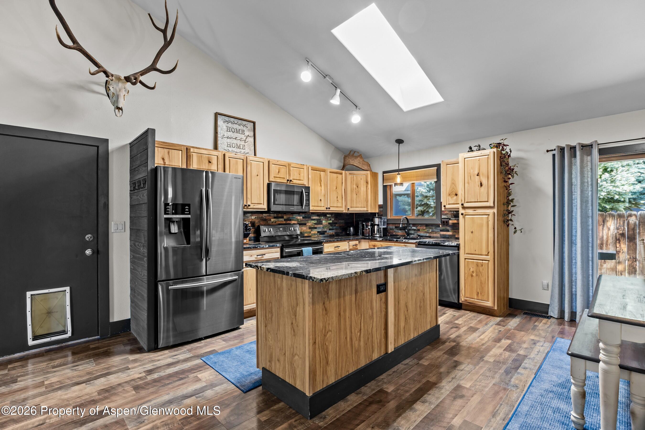 212 Safflower Court New Castle, CO 81647 - Photo 8 of 27 a kitchen with stainless steel appliances granite countertop a refrigerator a stove a sink and a refrigerator