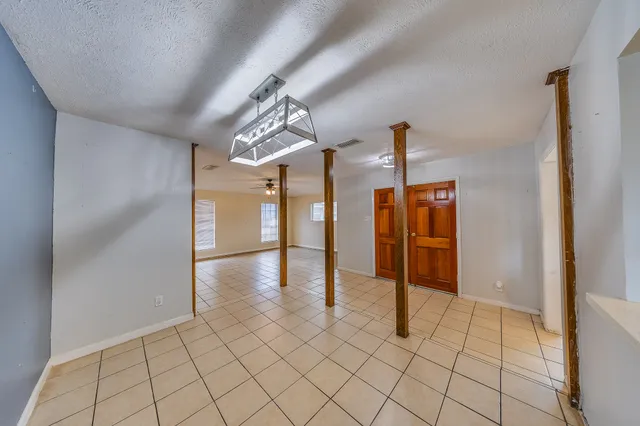 a view of a kitchen with furniture and an empty room