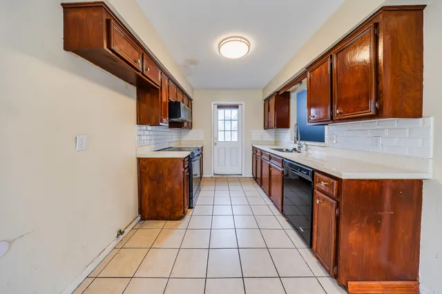 a bathroom with a granite countertop sink a toilet a mirror a bathtub and shower
