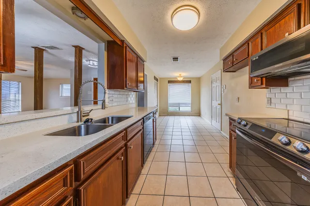 a view of a livingroom with a ceiling fan and window
