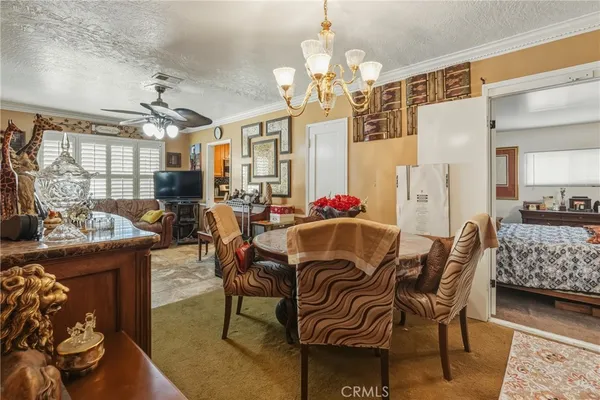 a view of a dining room with furniture and chandelier