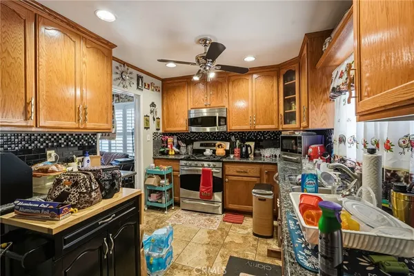 a kitchen with stainless steel appliances granite countertop a stove and a sink