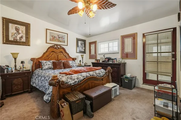 a bedroom with a bed and wooden cabinets