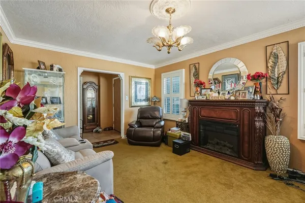 a living room with furniture a chandelier and a fireplace