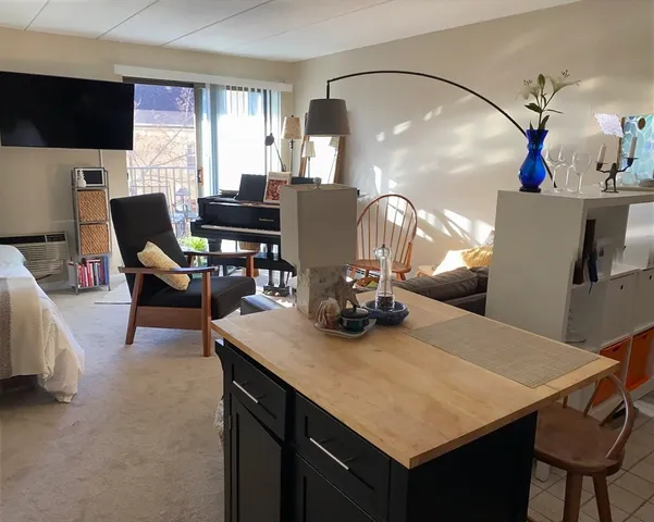 a dining room with furniture and a flat screen tv
