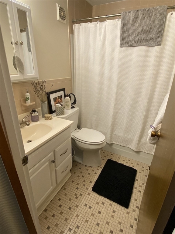 60 Pleasant Street, Unit 211 Arlington, MA 02476 - Photo 12 of 12 a bathroom with a sink toilet and shower