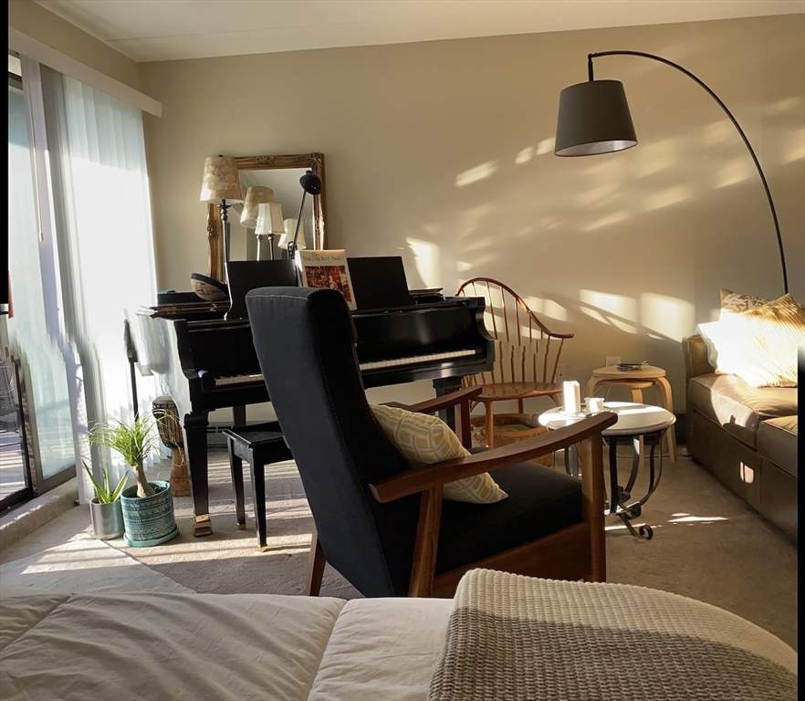 60 Pleasant Street, Unit 211 Arlington, MA 02476 - Photo 6 of 12 a dining room with furniture and wooden floor