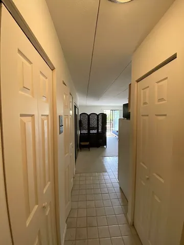 a view of a hallway with a refrigerator
