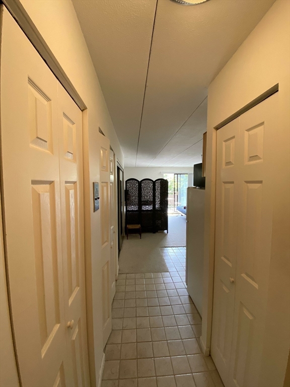 60 Pleasant Street, Unit 211 Arlington, MA 02476 - Photo 9 of 12 a view of a hallway with a refrigerator