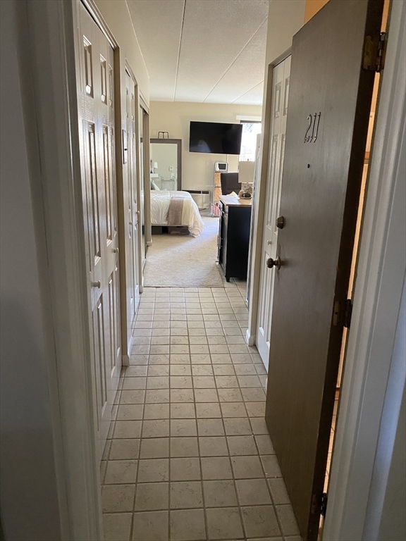60 Pleasant Street, Unit 211 Arlington, MA 02476 - Photo 10 of 12 a view of a hallway with a couch