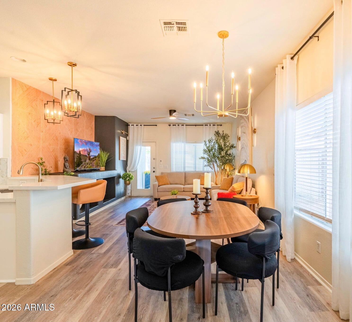 3674 South Joshua Tree Lane Gilbert, AZ 85297 - Photo 13 of 30 a kitchen with a table chairs and a chandelier
