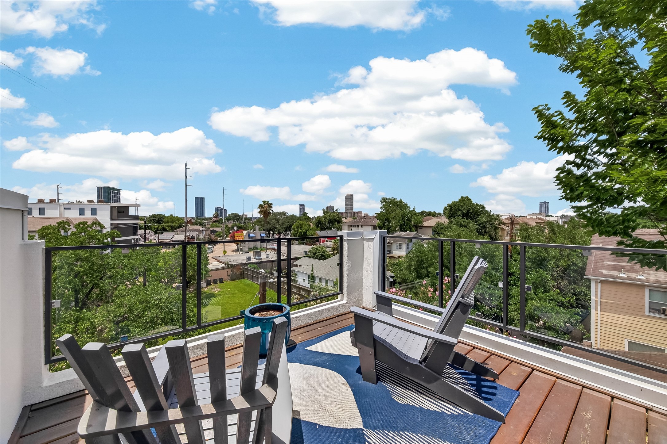 1767 Michigan Street Houston, TX 77006 - Photo 28 of 33 The rooftop deck, offering a scenic view of the city skyline and greenery. Perfect for relaxation and enjoying the outdoors.