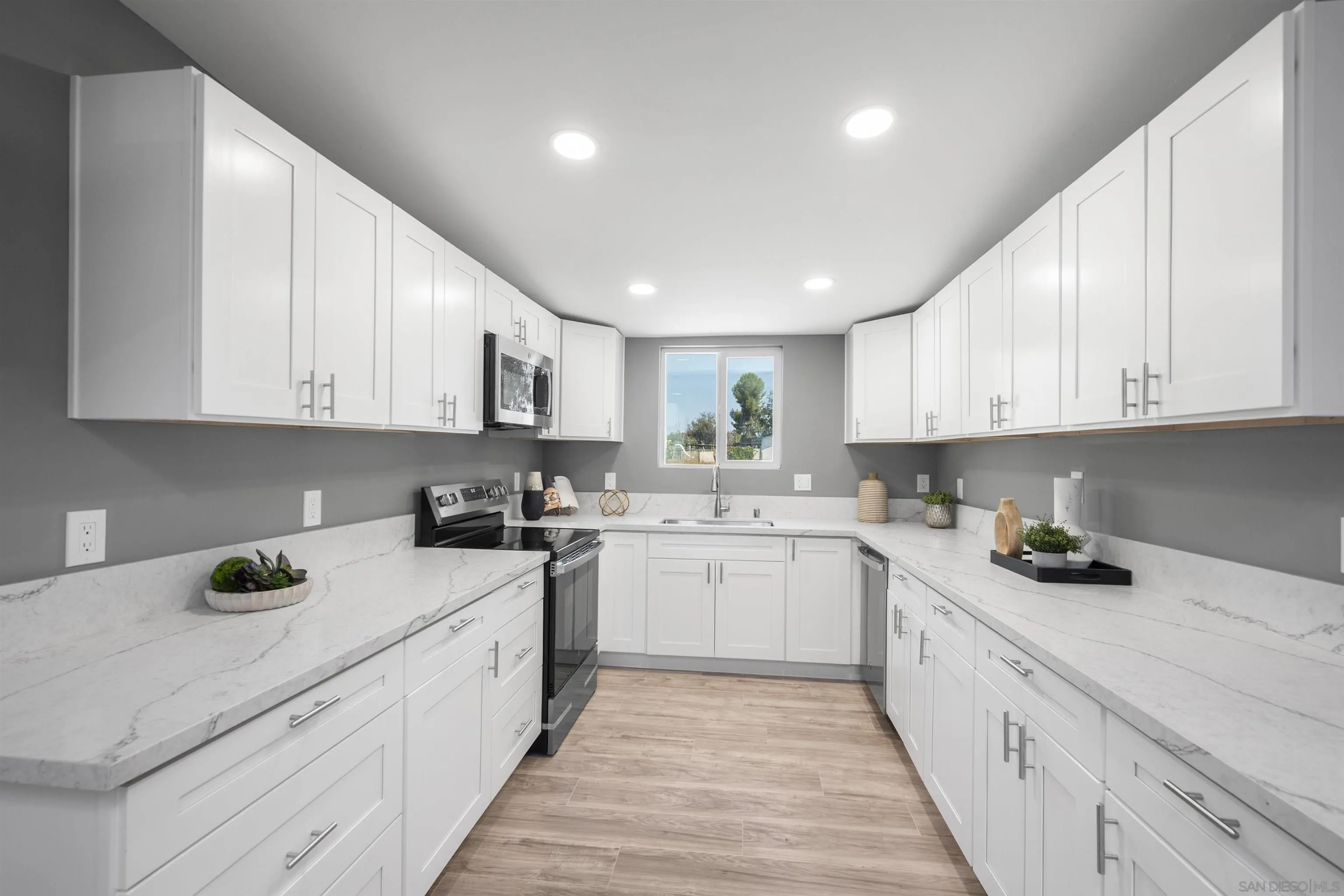 2235 Toub Street Ramona, CA 92065 - Photo 13 of 33 a kitchen with a sink stove top oven and cabinets