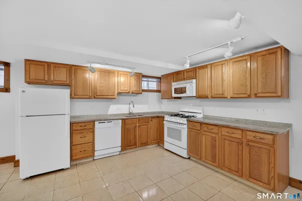 a kitchen with stainless steel appliances granite countertop a refrigerator sink and cabinets