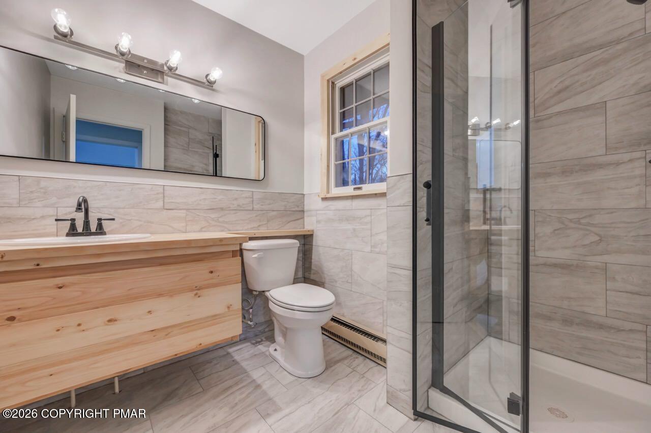 384 Devils Hole Road Cresco, PA 18326 - Photo 30 of 97 a bathroom with a toilet sink a mirror and shower