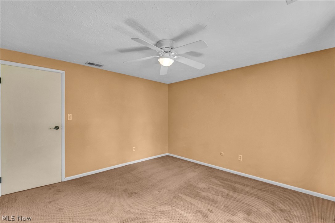 6845 Liberty Road Solon, OH 44139 - Photo 32 of 47 Carpeted interior space with a ceiling fan with integrated lighting, white trim, and a white interior door