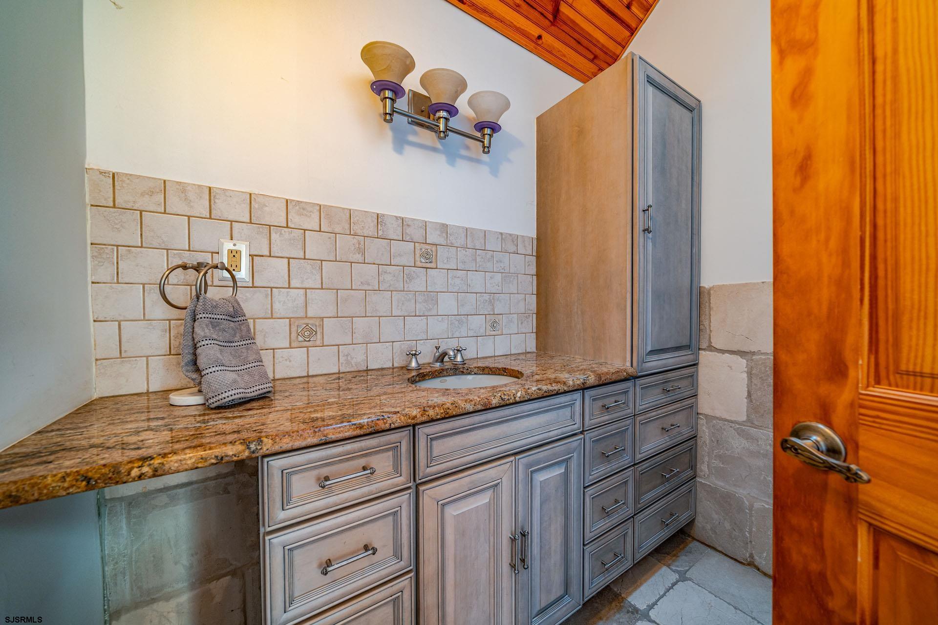 105 Tyler Road Woodbine, NJ 08270 - Photo 14 of 51 a bathroom with a granite countertop sink and a mirror