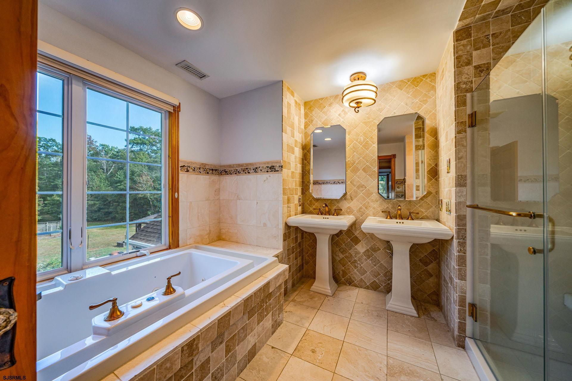 105 Tyler Road Woodbine, NJ 08270 - Photo 30 of 51 a bathroom with a tub sink and mirror