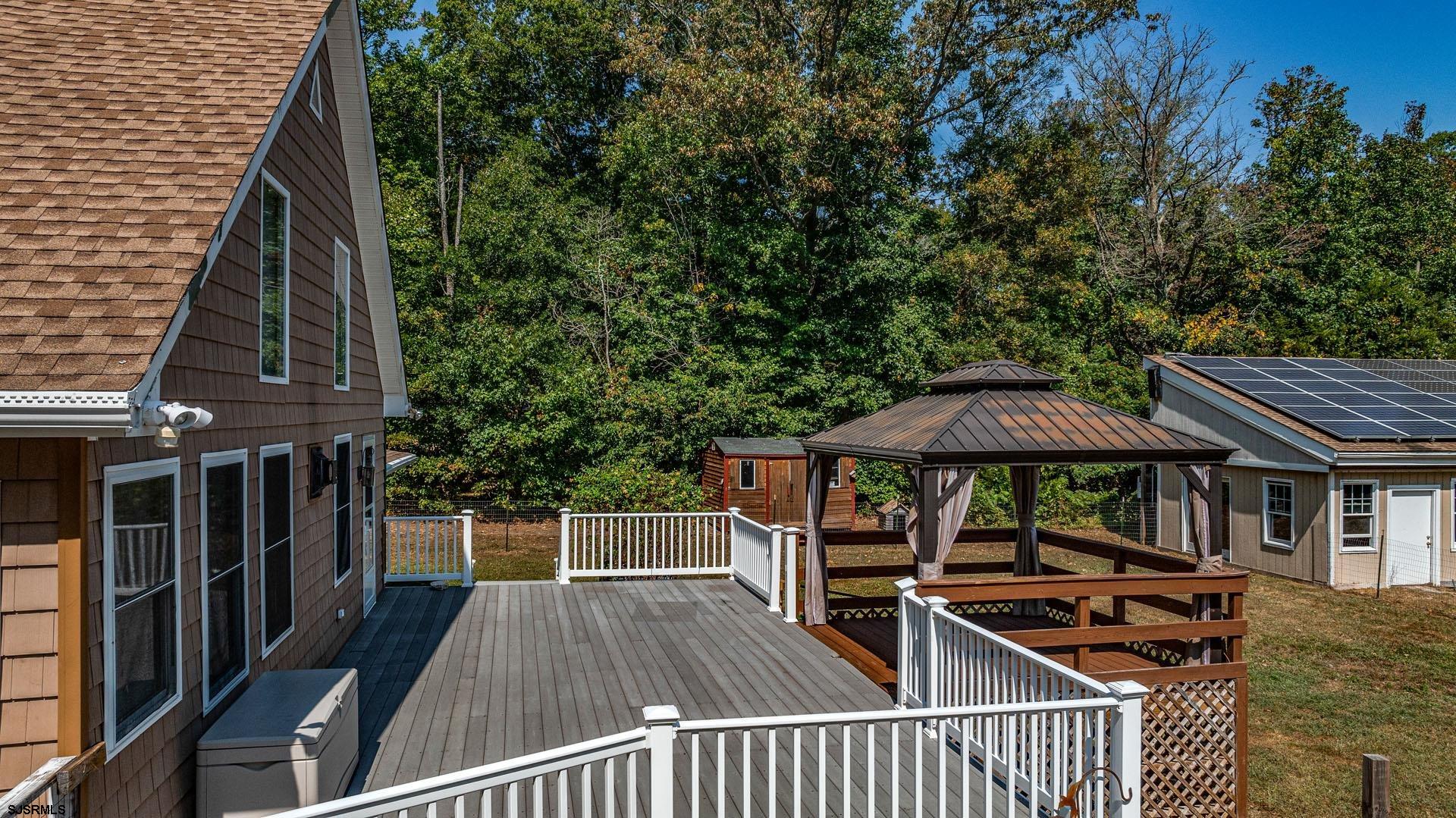 105 Tyler Road Woodbine, NJ 08270 - Photo 5 of 51 a view of a patio with table and chairs under an umbrella with wooden fence