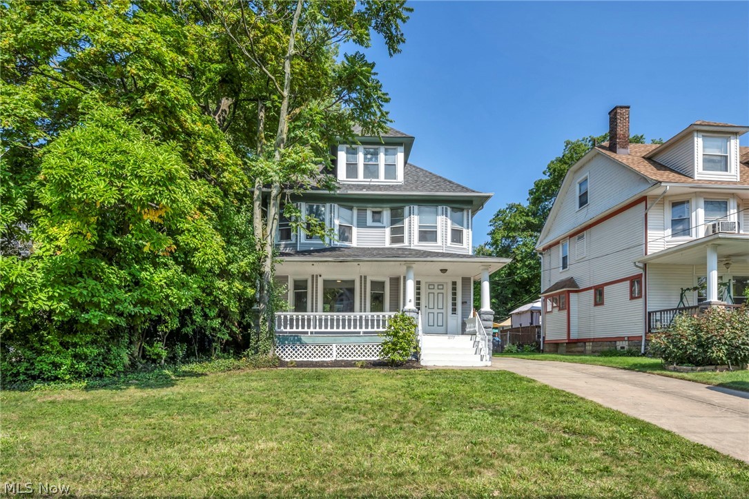 1659 Lee Road Cleveland, OH 44118 - Photo 1 of 46 Two-story residence featuring a covered front porch, white railings, and a dormer window