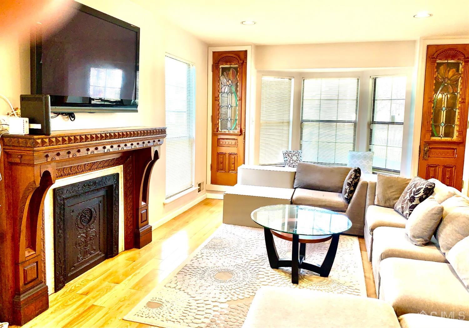 1001 Timber Oaks Road, Unit 1001 Edison, NJ 08820 - Photo 11 of 25 a living room with a fireplace and a flat screen tv