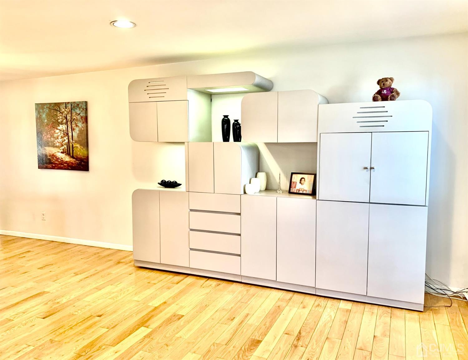 1001 Timber Oaks Road, Unit 1001 Edison, NJ 08820 - Photo 13 of 25 a storage room with wooden floor and cabinets