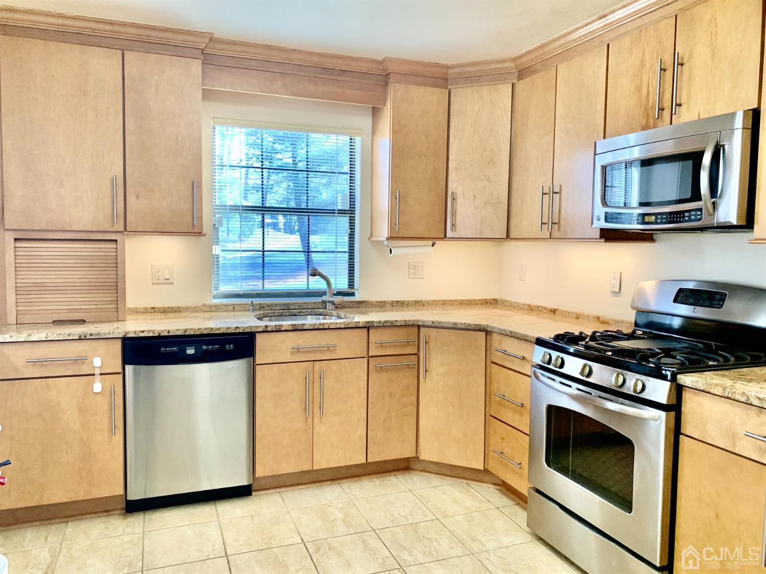 1001 Timber Oaks Road, Unit 1001 Edison, NJ 08820 - Photo 16 of 25 a kitchen with granite countertop white cabinets and appliances