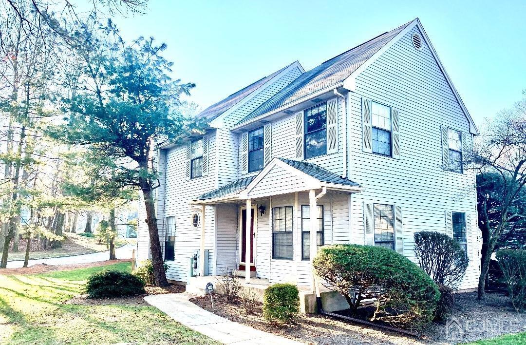 1001 Timber Oaks Road, Unit 1001 Edison, NJ 08820 - Photo 6 of 25 a front view of a house with a yard