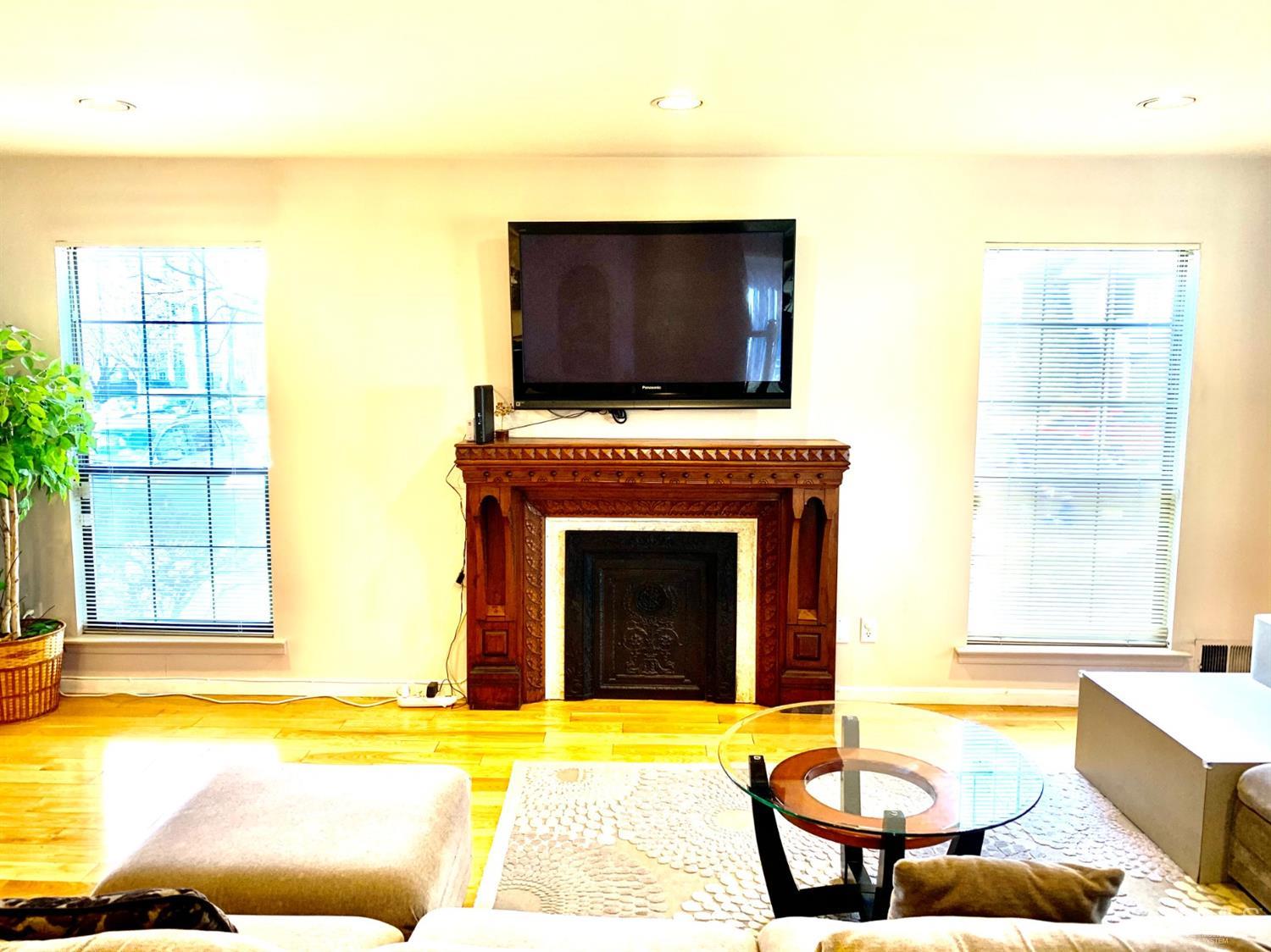 1001 Timber Oaks Road, Unit 1001 Edison, NJ 08820 - Photo 7 of 25 a living room with a fireplace and a flat screen tv