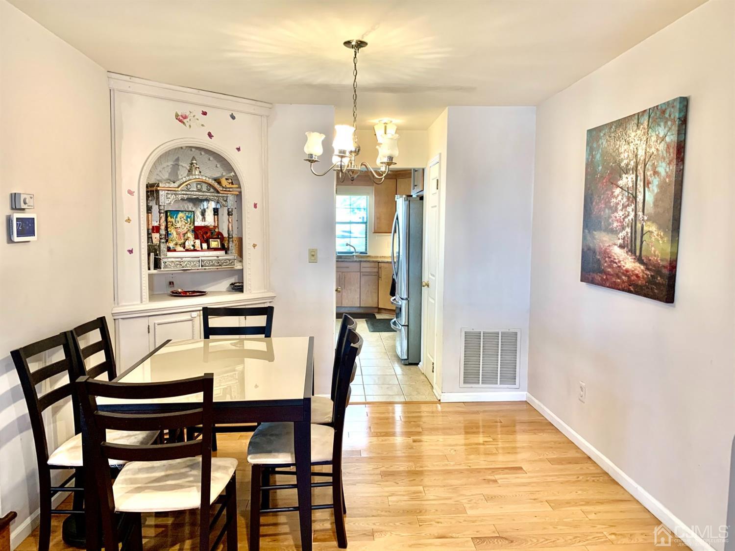 1001 Timber Oaks Road, Unit 1001 Edison, NJ 08820 - Photo 8 of 25 a view of a dining room with furniture window and wooden floor