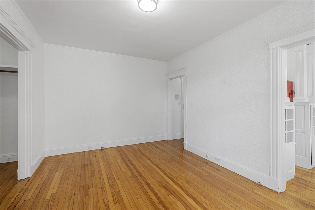 170 Maple Street, Unit 110 Malden, MA 02148 - Photo 7 of 23 a view of empty room with wooden floor