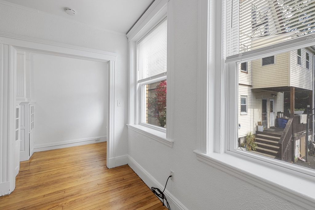 170 Maple Street, Unit 110 Malden, MA 02148 - Photo 8 of 23 a view of a room with wooden floor and stairs