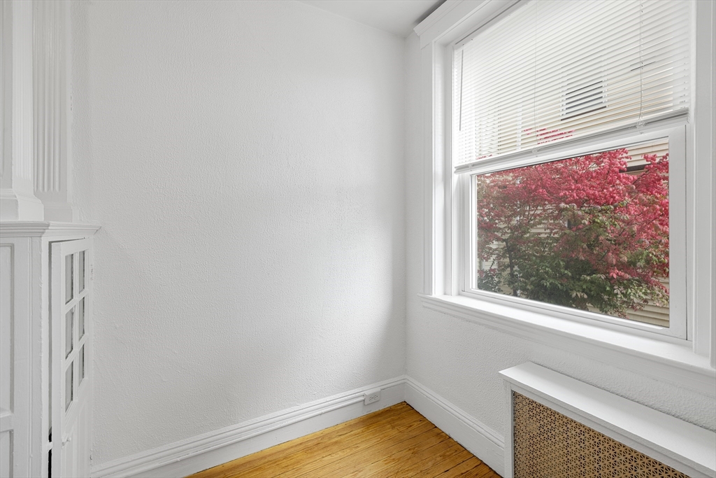 170 Maple Street, Unit 110 Malden, MA 02148 - Photo 10 of 23 a view of a livingroom with wooden floor and a window