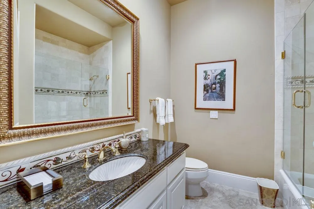 7745 St Andrews Road Rancho Santa Fe, CA 92067 - Photo 14 of 29 a bathroom with a granite countertop sink toilet and a mirror