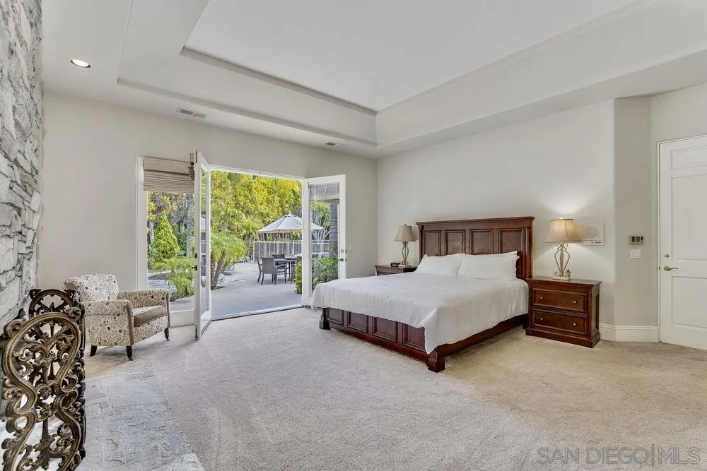 7745 St Andrews Road Rancho Santa Fe, CA 92067 - Photo 16 of 29 a bedroom with a bed lamp and a large window