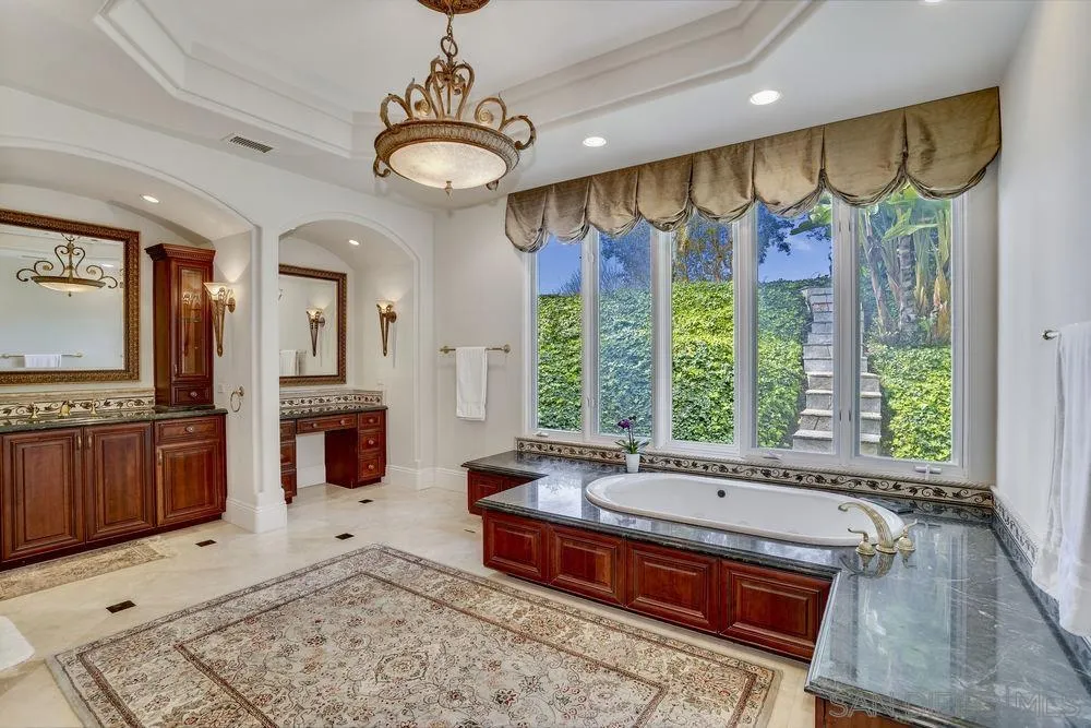 7745 St Andrews Road Rancho Santa Fe, CA 92067 - Photo 17 of 29 a spacious bathroom with a tub a sink and a large mirror