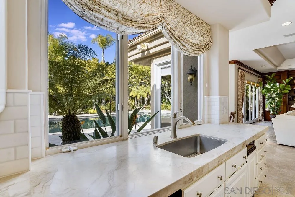 7745 St Andrews Road Rancho Santa Fe, CA 92067 - Photo 10 of 29 a view of a kitchen with a sink and dishwasher next to a large window