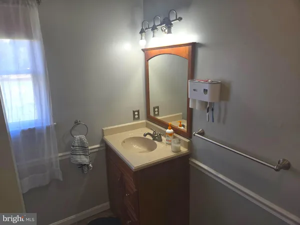 a bathroom with a sink vanity and mirror