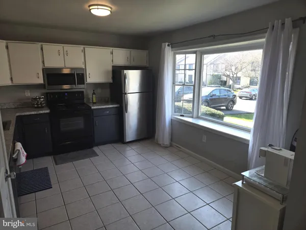a kitchen with a refrigerator and window