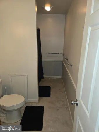a bathroom with a toilet and a shower