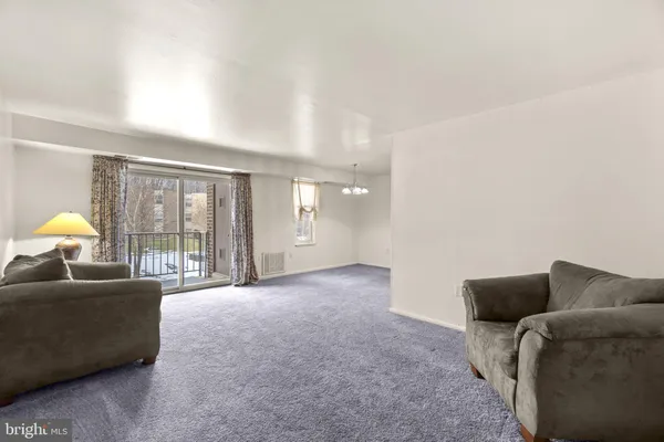 a living room with furniture and a lamp