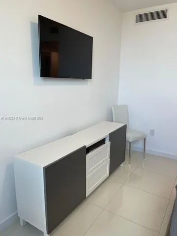 a living room with a flat screen tv and white door