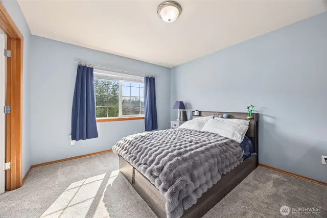 a bedroom with a bed and window