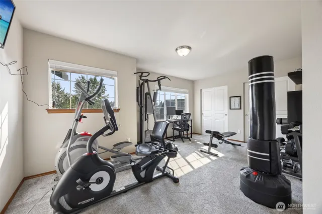 a room with gym equipment and windows
